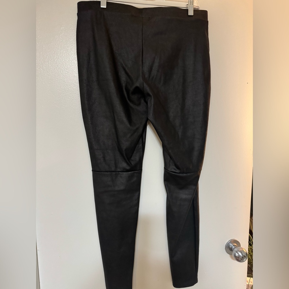 Black smooth texture with mid knee seam faux leather pants